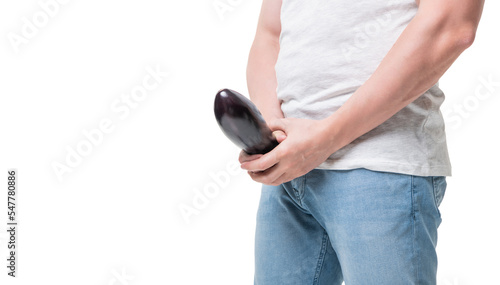 Man crop view holding eggplant at crotch level imitating erect penis isolated on white, copy space photo