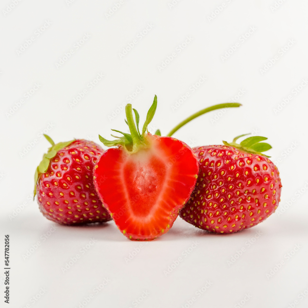 sliced freshly picked natural strawberries from the garden. highlighted on white. sliced freshly picked natural strawberries from the garden. highlighted on white.