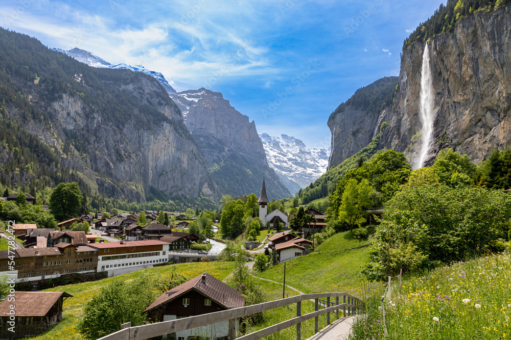 Landscape view of the town of Lauterbrunnen in the Canton of Bern in the Alps in Switzerland.  The Staubbach falls can be seen on the right.  