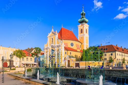 Vászonkép Gyor, Hungary. Carmelite Church and water fountain.