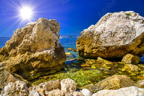 Sea beach with stones and rocks, Beausoleil, Nice, Nizza, Alpes-Maritimes, Provence-Alpes-Cote d'Azur, Cote d'Azur, French Riviera, France photo