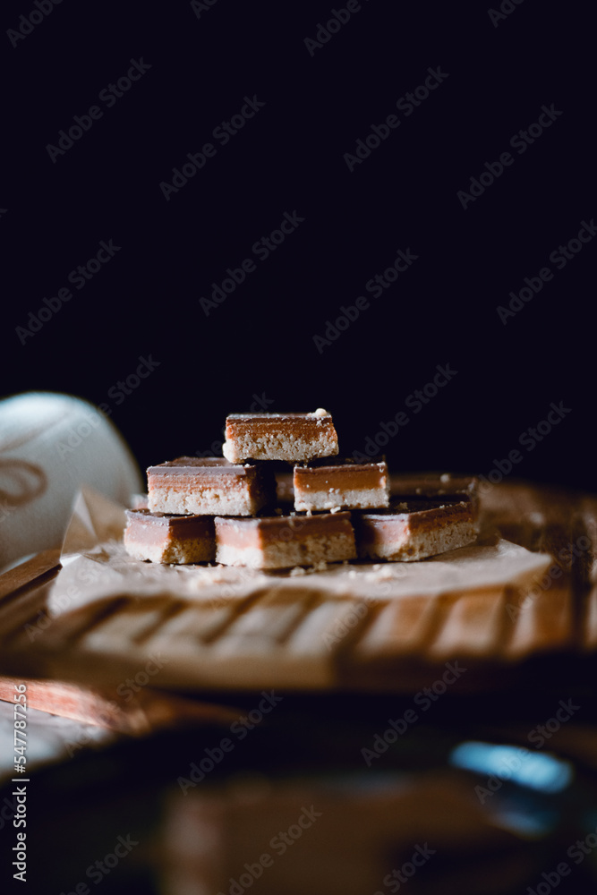 Mini caramel Millionaire's Shortbread served in kitchen with coffee Mini caramel Millionaire's Shortbread served in kitchen with coffee