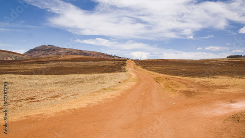 Dry andean landscape with dirt road going nowhere Cusco  Peru