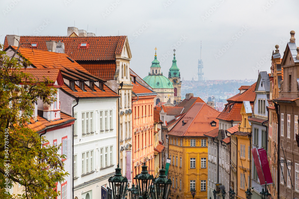Tourism in Europe. View on old streets of Prague in the morning, city center, Czech Republic, European travel. Typical old buildings with red tile roofs in Prague in foggy day. Tourism in Europe. View on old streets of Prague in the morning, city center, Czech Republic, European travel. Typical old buildings with red tile roofs in Prague in foggy day.