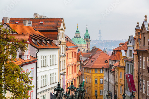 Tourism in Europe. View on old streets of Prague in the morning, city center, Czech Republic, European travel. Typical old buildings with red tile roofs in Prague in foggy day. 
