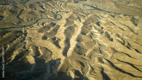 Gorgeous aerial drone top bird's eye view of incredible golden desert mountains of tzin river. desert in Israel