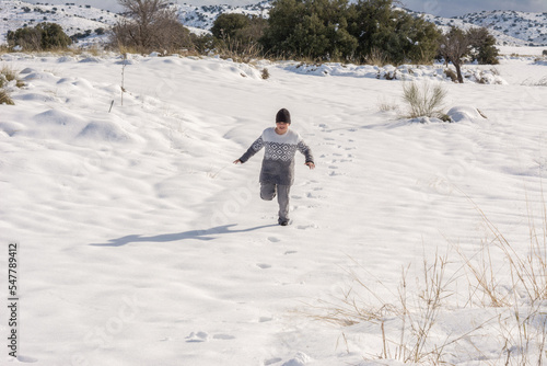 child running and enjoying the snowy landscape