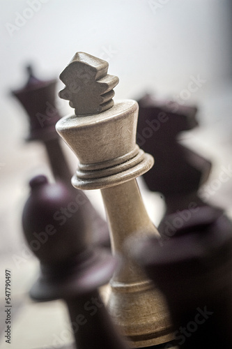 white chess king surrounded by black pieces. photo
