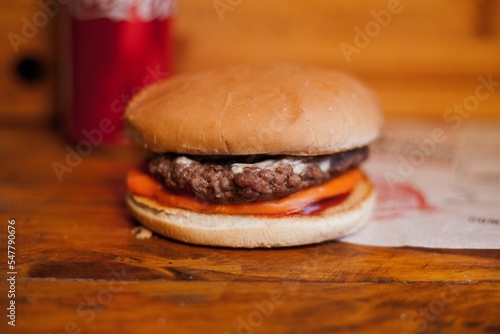 samsh burger with cheddar, katchup, under a wooden table (ID: 547790676)