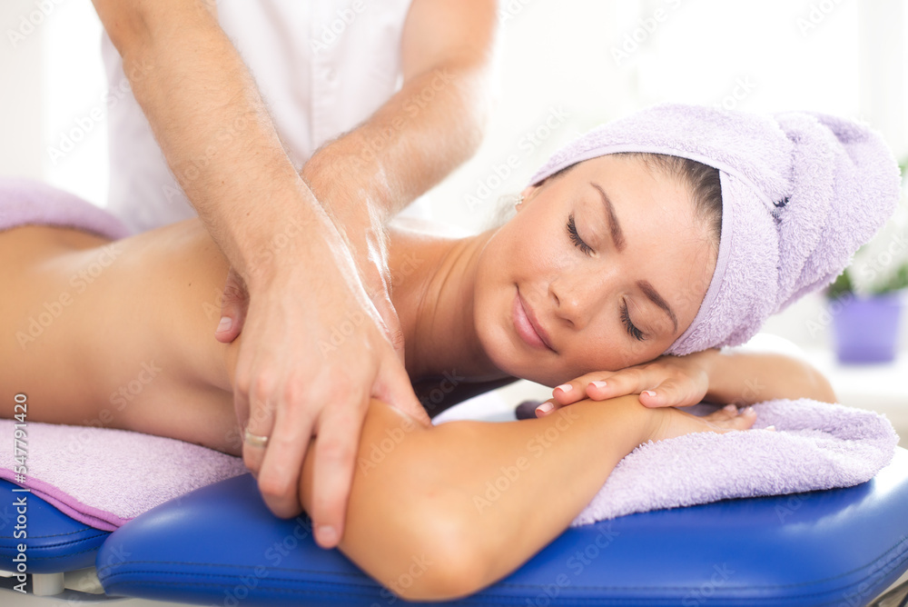 Young woman getting massage in massage salon, health spa Young woman getting massage in massage salon, health spa