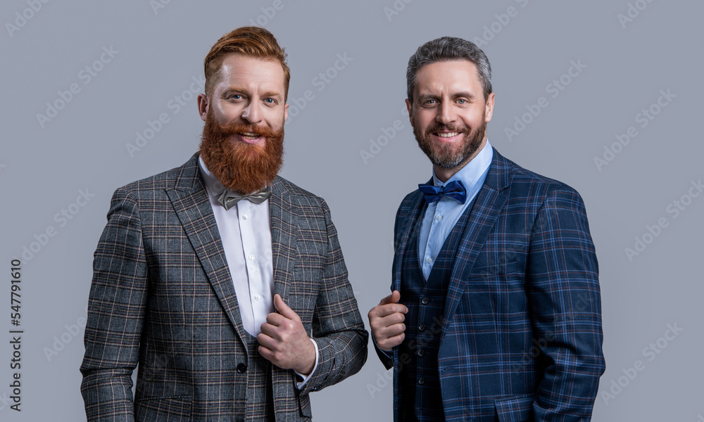 happy elegant men in formal tux suit. tux men isolated on grey background. two men in tux. happy elegant men in formal tux suit. tux men isolated on grey background. two men in tux.