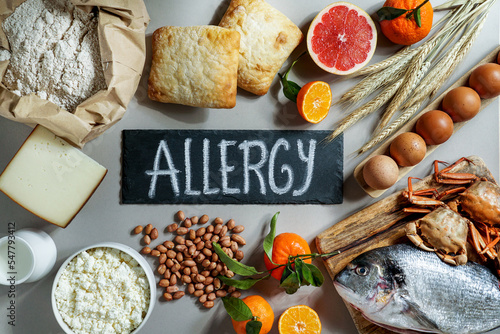 Allergy food concept. allergene - milk, fish, strawberry, bread, eggs, peanuts, citrus, wheat flower and others on grey backgrond