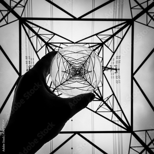 electric pylon reflection in glass ball in black and white  photo