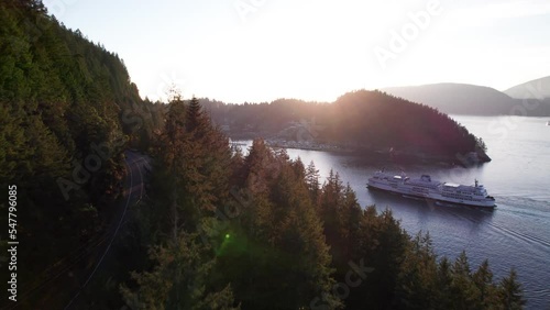 Car ferry boat sailing into dock in scenic bay surrounded by mountains, sun rays ocean, tranquil scene, Horseshoe Bay ferry terminal. 24FPS 4K PRORES 422