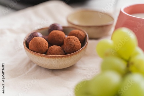 Close-up shot of chocolate truffles on a table isolated with blurred background