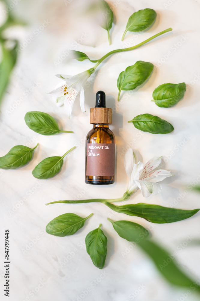 skin care serum with flowers on white background, above view skin care serum with flowers on white background, above view