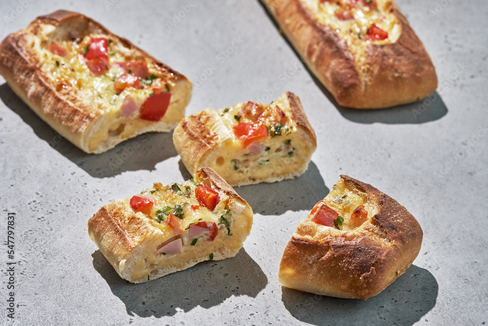 Bread boats stuffed with ham, egg, green onion and cheese for breakfast Bread boats stuffed with ham, egg, green onion and cheese for breakfast