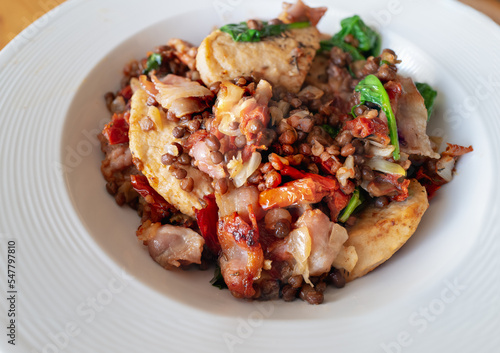 Soya chicken fillets with bacon in a dish with also includes spinach, onions, lentils and sun-dried tomatoes.