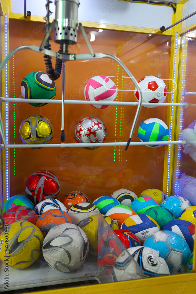 Electronic claw machine to grab soccer balls. Claw machine. Arcade