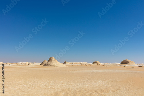 Dramatic White Desert landscape with a blue sky background.