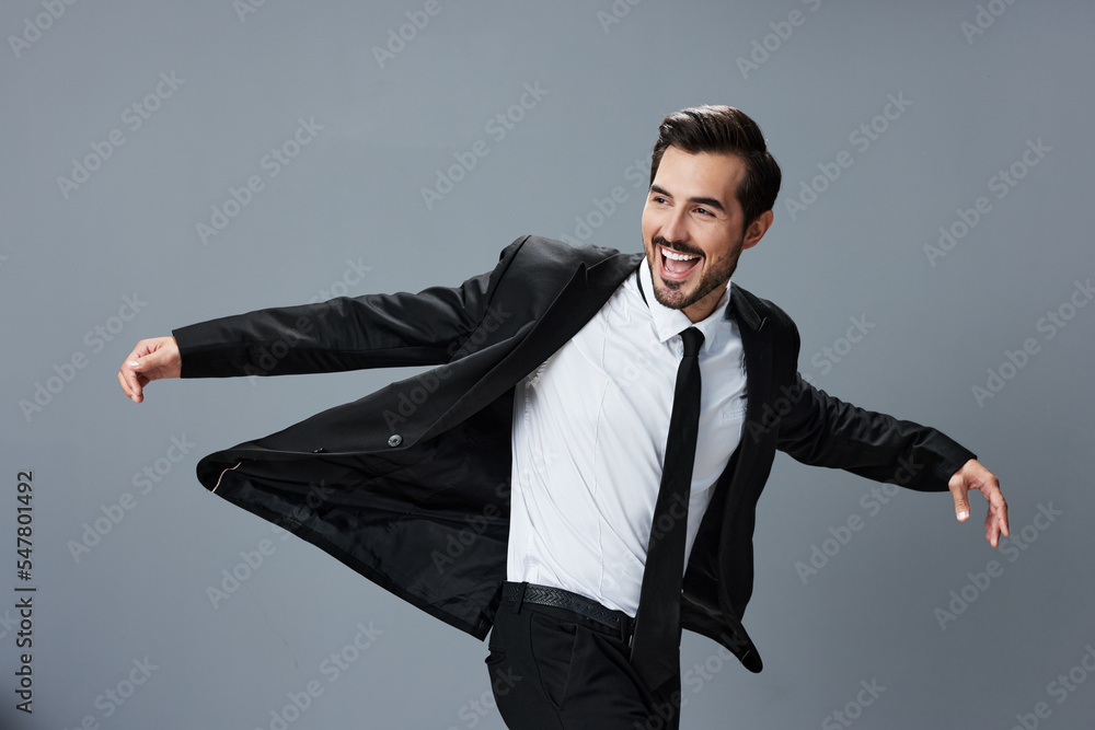 Business man in jacket and shirt jumps and runs on gray background raised hands up smile with teeth Business man in jacket and shirt jumps and runs on gray background raised hands up smile with teeth
