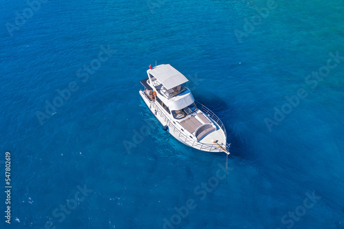 Tropical beach white yacht on blue sea Antalya, Turkey Aerial top view. Concept beautiful travel summer landscape © Parilov