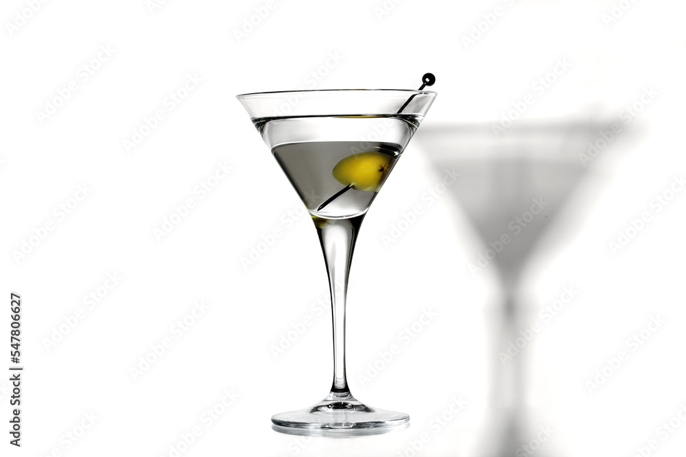 Martini glass with olives on white background