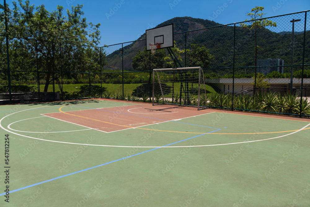 Fototapeta premium View of a sports court with beams and table with basket inside a park. Widely used for football, basketball and volleyball