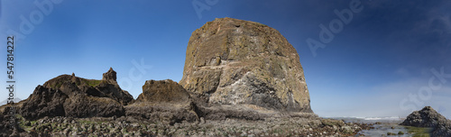 Panoramic shot of Haystack Rock on the Oregon Coast. 