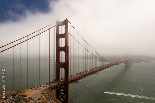 Golden Gate Bridge partially hidden in fog, San Francisco, California, USA.