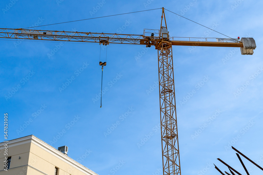 Construction site with cranes against blue sky. Industrial background. Modern skyscrapers. Unfinished construction	