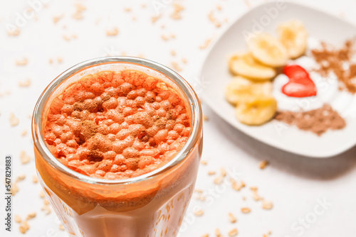 Tascalate smoothie on a white background with ingredients on a plate.