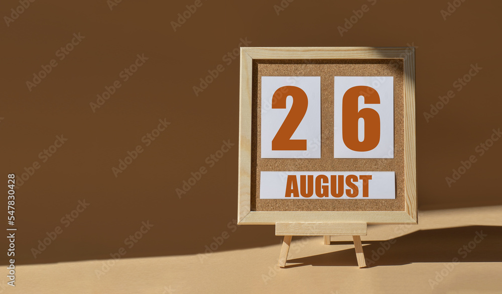 August 26th. Day 26 of month, Calendar date. Cork board, easel in sunlight on desktop. Close-up, brown background. Summer month, day of year concept August 26th. Day 26 of month, Calendar date. Cork board, easel in sunlight on desktop. Close-up, brown background. Summer month, day of year concept
