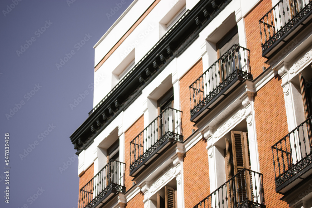 Naklejka premium Madrid, Spain. August 1 2022 Red brick building facade balconies apartment house