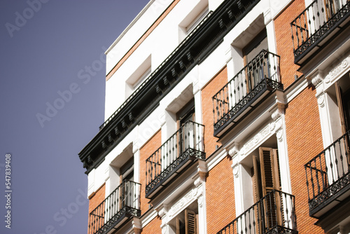 Madrid, Spain. August 1 2022 Red brick building facade balconies apartment house