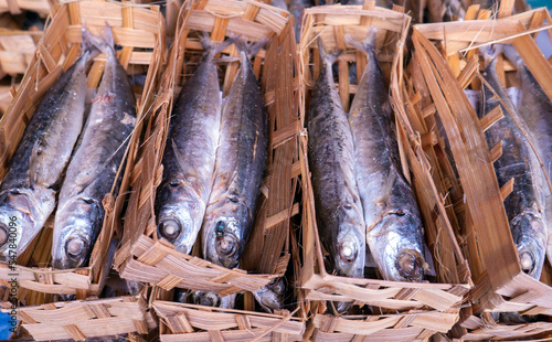 Ikan Pindang or salted fish in bamboo packaging on traditional market, in Yogyakarta, Indonesia photo