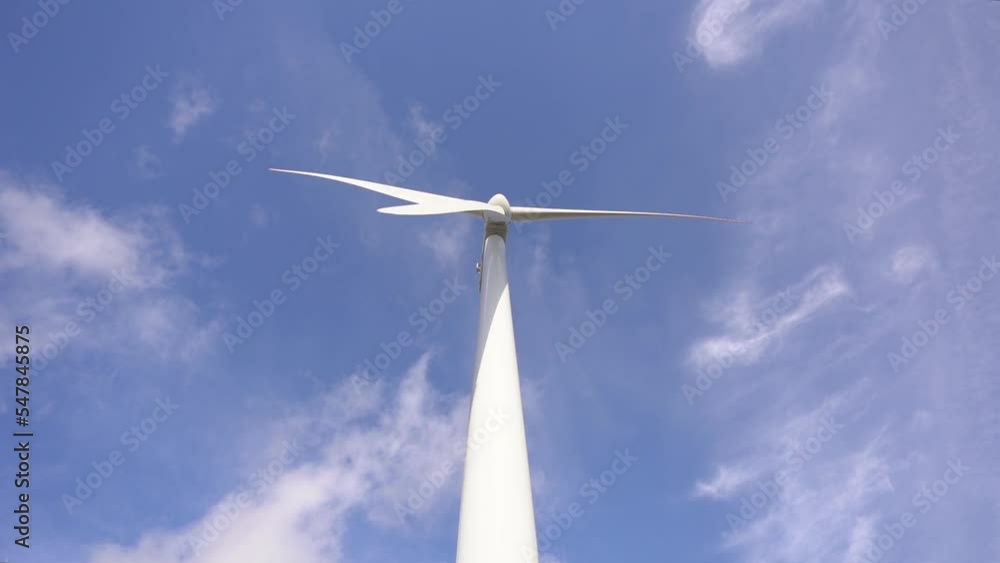 Wind Turbine Propeller Spinning Against Blue Sky With Clouds.wide Wind Turbine Propeller Spinning Against Blue Sky With Clouds.wide
