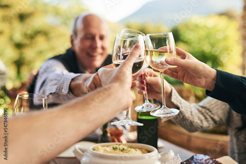 Fotobehang Friends, wine and toast on a patio with happy, cheerful and people celebrating and sharing a meal outdoors