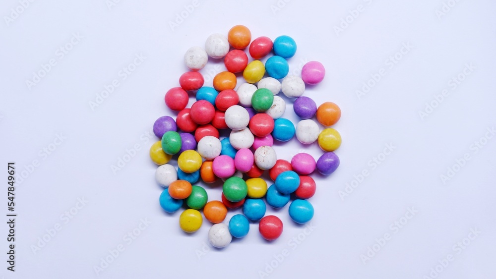 Marbles candy, Lollipops sweets. Candy, top view flat lay on white background. Sweet sucker, lollipop, candy, isolated minimal concept above decoration, food background Marbles candy, Lollipops sweets. Candy, top view flat lay on white background. Sweet sucker, lollipop, candy, isolated minimal concept above decoration, food background