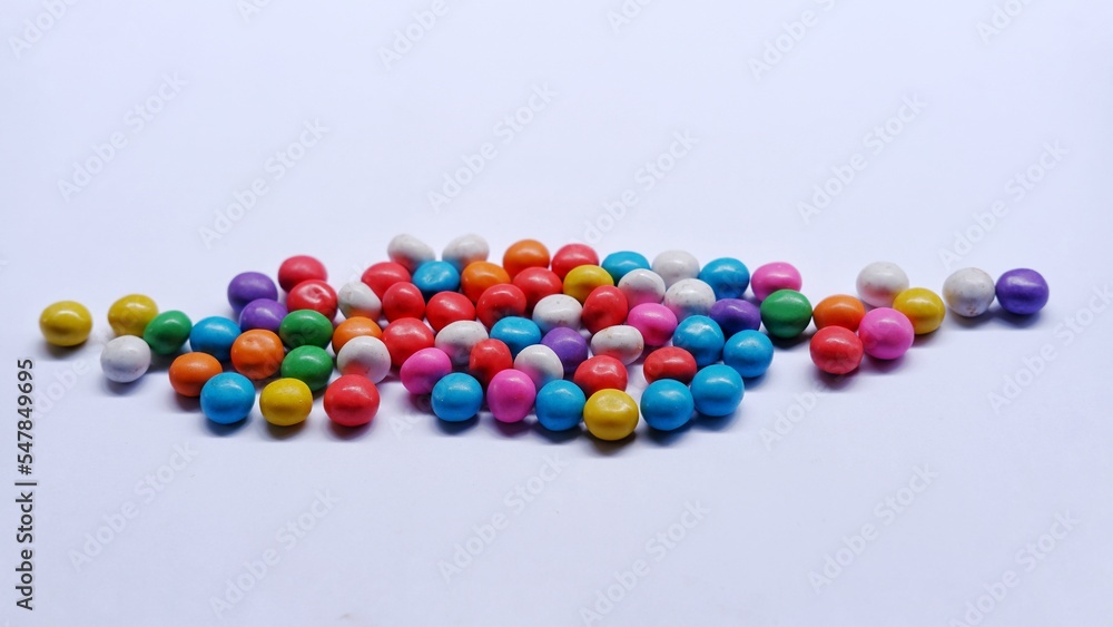 Marbles candy, Lollipops sweets. Candy, top view flat lay on white background. Sweet sucker, lollipop, candy, isolated minimal concept above decoration, food background Marbles candy, Lollipops sweets. Candy, top view flat lay on white background. Sweet sucker, lollipop, candy, isolated minimal concept above decoration, food background
