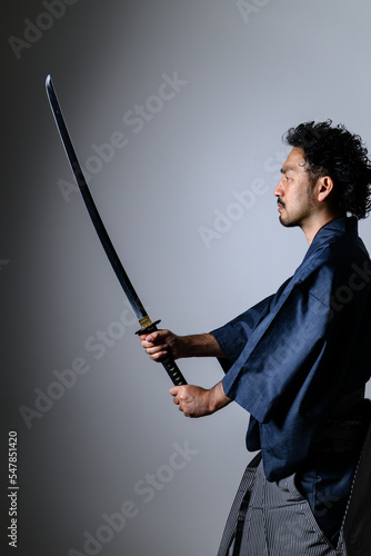Image of a cool Japanese 「samurai 」with a sword vertical