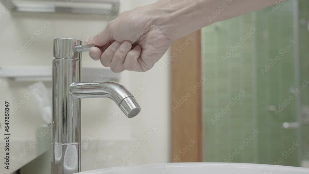 faucet in the bathroom with running water. keeps turning off the water