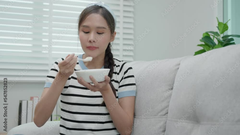 Beautiful girl enjoy eat yogurt on breakfast health in house. Happy young woman smile on morning for good emotion. female Clean eat, dieting, detox, yogurt diet. Diet Happy and Healthy food concept Beautiful girl enjoy eat yogurt on breakfast health in house. Happy young woman smile on morning for good emotion. female Clean eat, dieting, detox, yogurt diet. Diet Happy and Healthy food concept