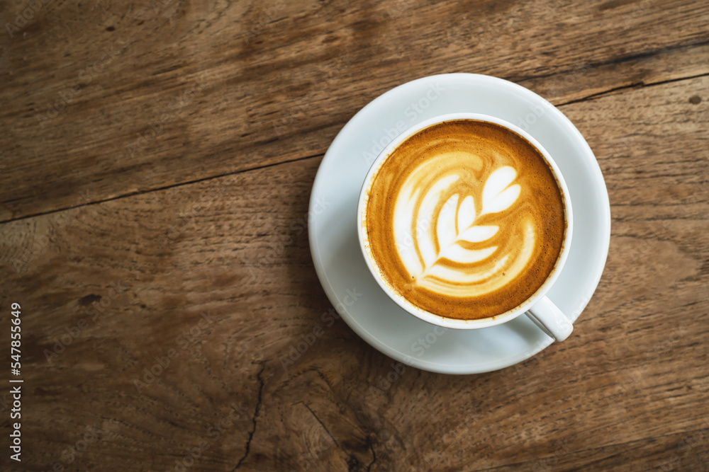 Cup of hot latte art coffee on the wooden table. morning drink concept Cup of hot latte art coffee on the wooden table. morning drink concept