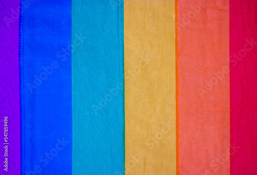 Abstract striped LGBT flag background texture. Textile or paper backdrop of rainbow bright colors. Vertical colorful stripes. Pride month concept. Holiday celebrating with gays, lesbians in June.