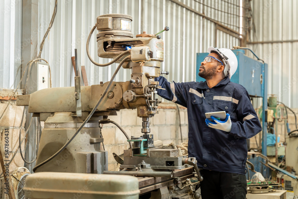 Team of engineers practicing maintenance Taking care and practicing maintenance of old machines in the factory so that they can be used continuously.