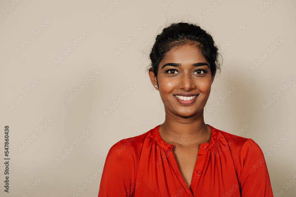 Young brunette indian woman smiling and looking at camera Young brunette indian woman smiling and looking at camera