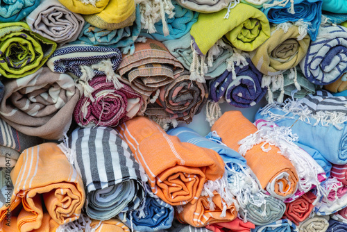 A bunch of twisted towels and textiles in the street shop. Different colors. Turkey (Turkiye)
