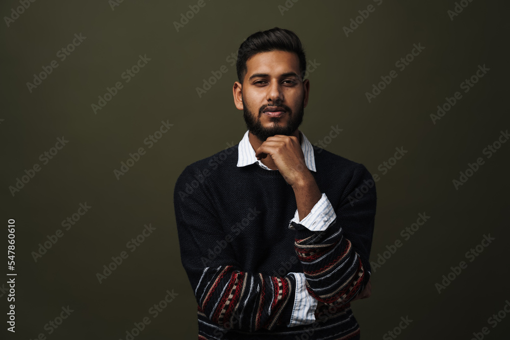 Portrait of confident indian man in pullover over shirt isolated Portrait of confident indian man in pullover over shirt isolated