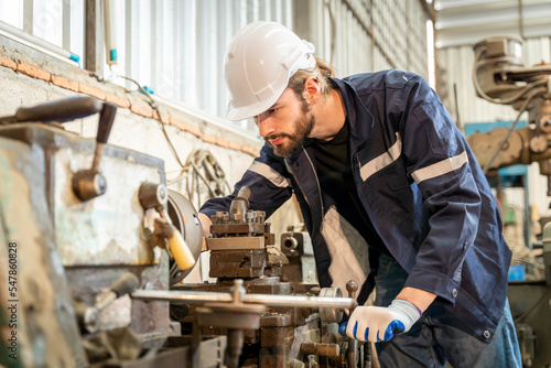 Team of engineers practicing maintenance Taking care and practicing maintenance of old machines in the factory so that they can be used continuously.